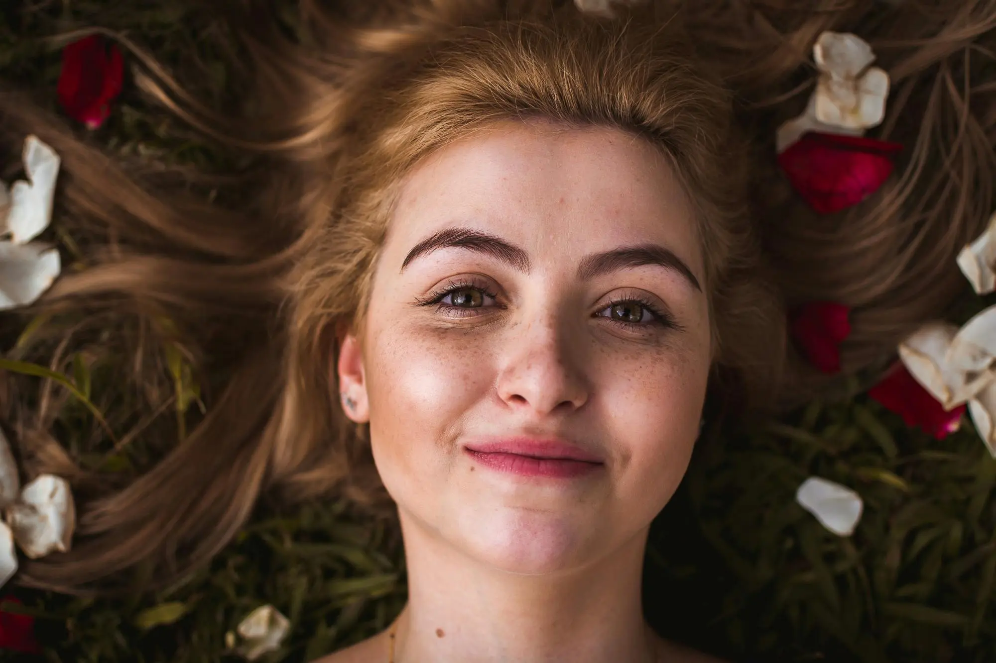 Model lying in a flower field
